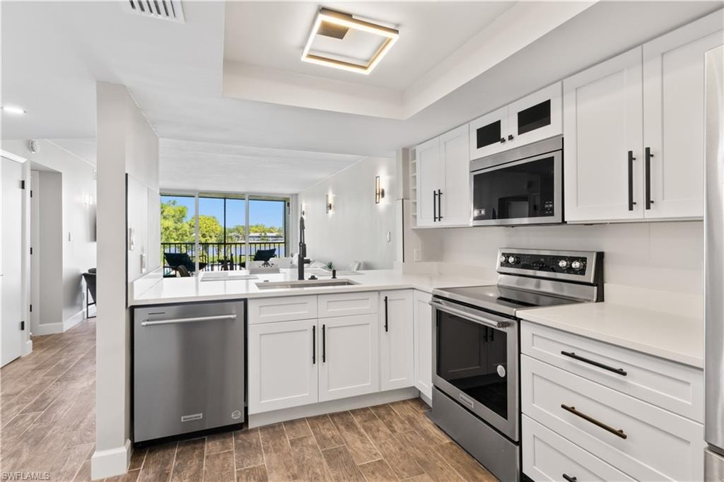 Enjoy the calming lake vista just beyond the kitchen while preparing meals in this beautifully updated space.