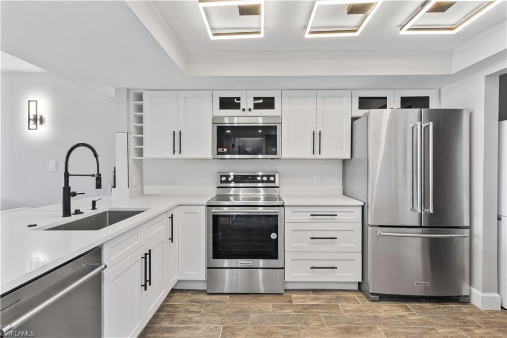 Modern kitchen fully remodeled with new stainless-steel appliances and sleek countertops.
