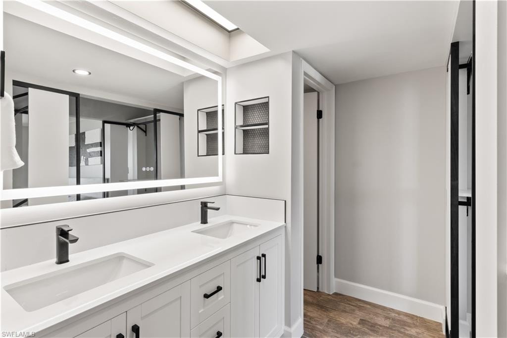 Bright and contemporary primary bathroom boasting a new dual vanity.