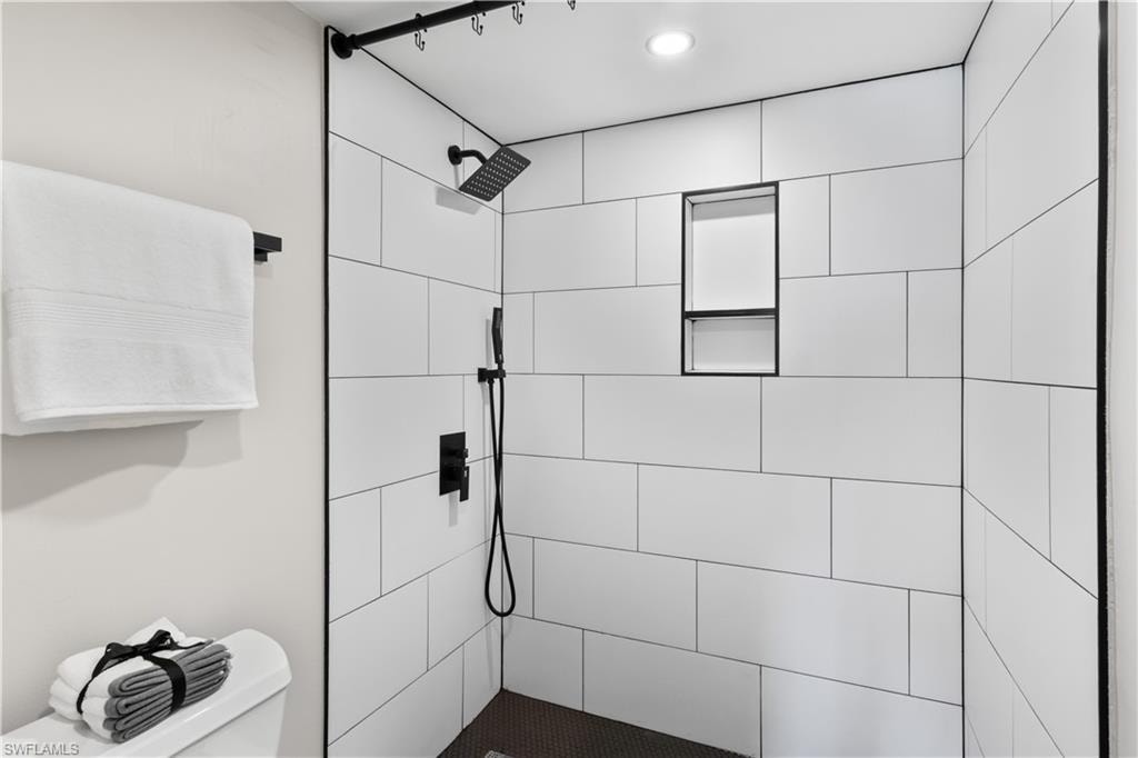 Spacious walk-in shower with modern accents.