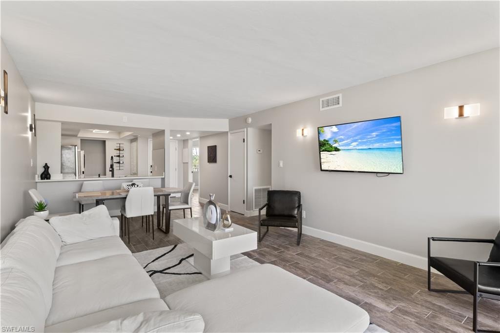 Generously sized living room with tranquil lake views, thoughtfully designed to host gatherings with ease and grace.