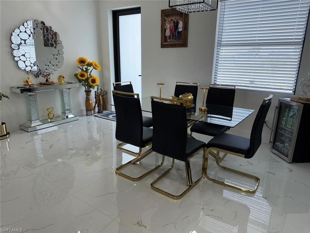 Dining room with beverage cooler and marble finish floor