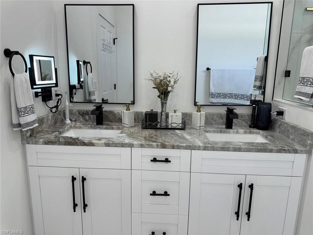Full bath with a sink and double vanity