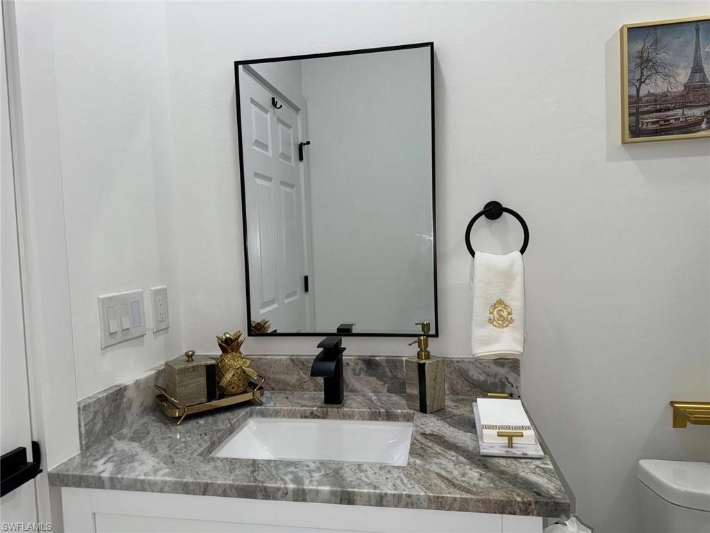 Half bathroom with toilet and vanity