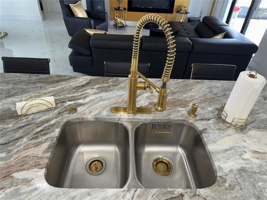 Room details featuring a sink and stone countertops