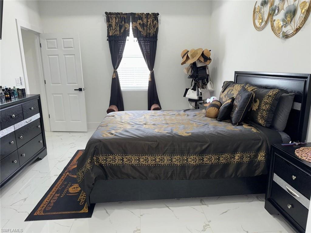 Bedroom with marble finish floor