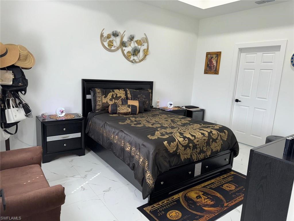Bedroom with visible vents and marble finish floor