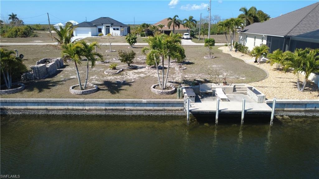 Dock area with a water view and a residential view