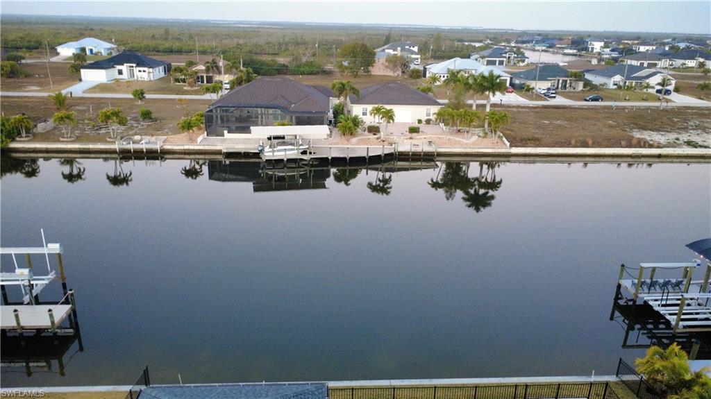 Aerial perspective of suburban area featuring a large body of water