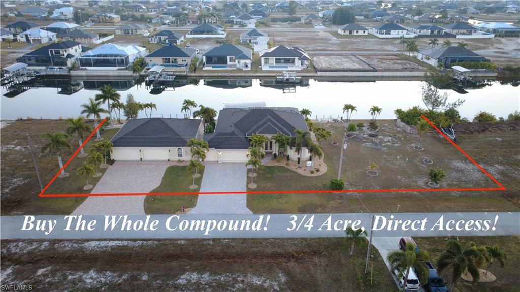 Aerial perspective of suburban area featuring property parcel outlined and a nearby body of water