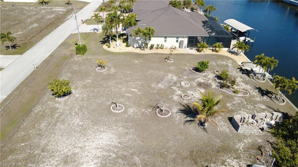 Aerial view of property and surrounding area featuring a nearby body of water