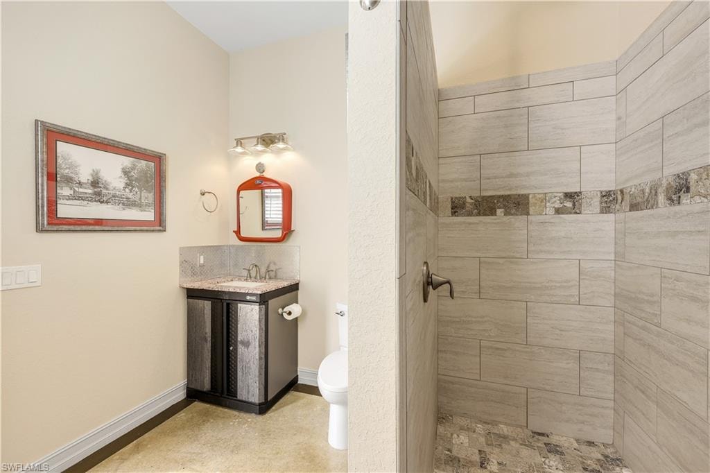 Full bath with a tile shower and vanity