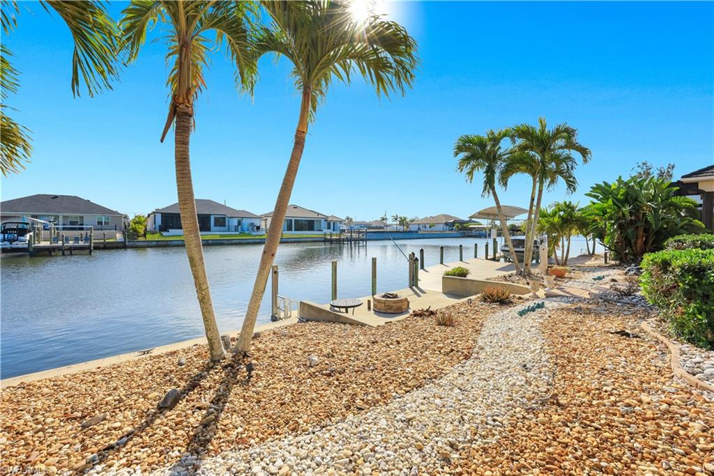 Water view with a boat dock and nearby suburban area