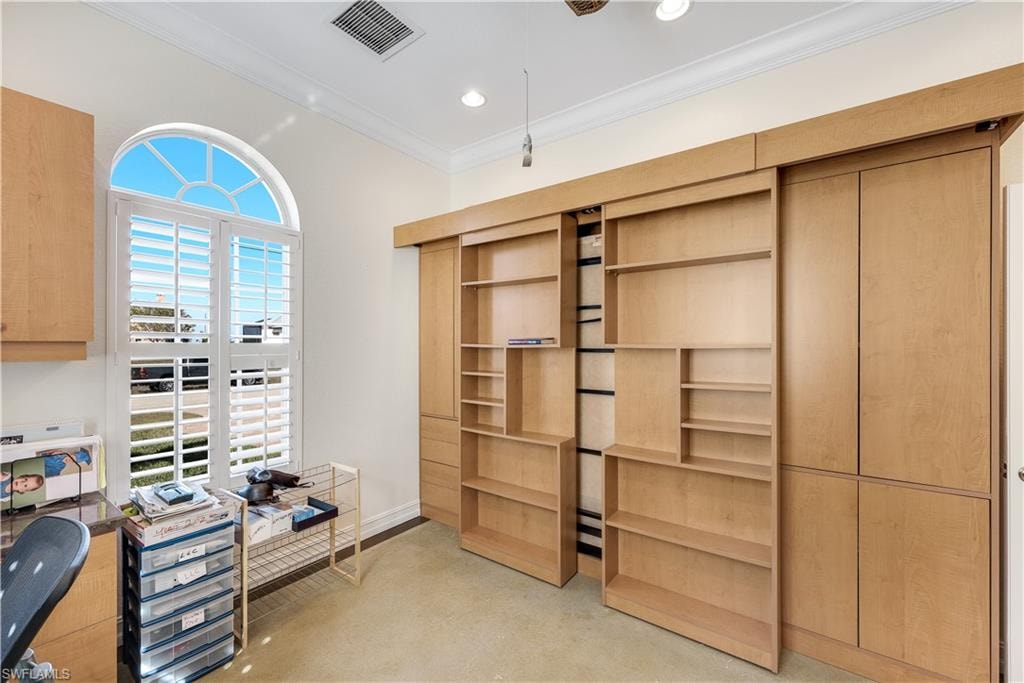 Office space featuring finished concrete floors, ornamental molding, and recessed lighting