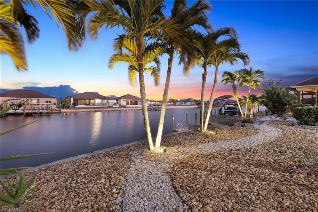 Water view with a boat dock and nearby suburban area