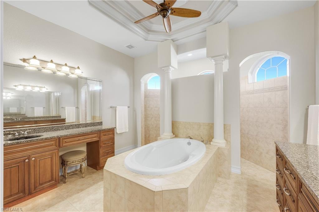 Bathroom featuring vanity, a walk in shower, a garden tub, and light tile patterned floors