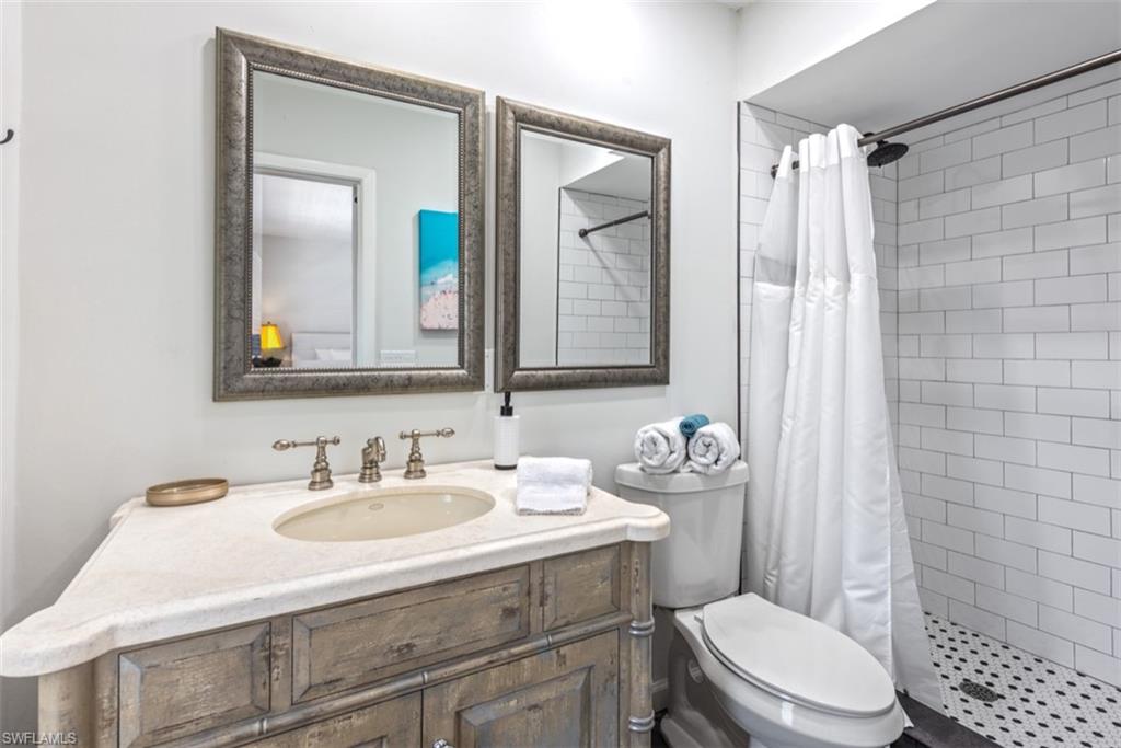 Bathroom featuring vanity and a shower stall