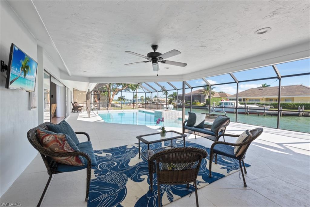 Outdoor pool with a lanai, a sunroom, and a patio