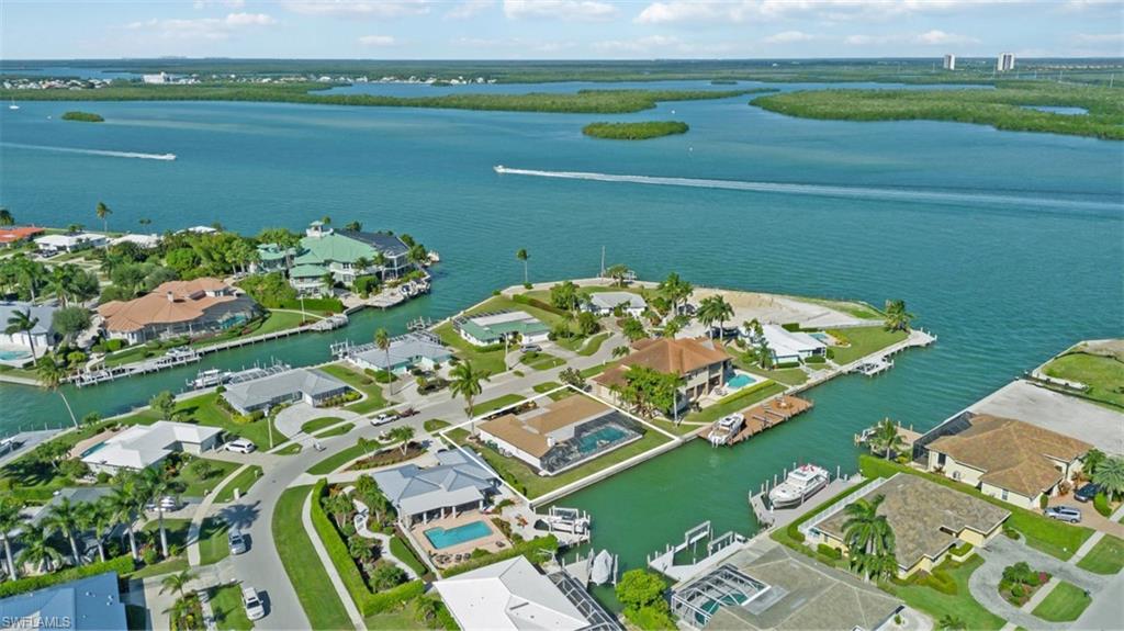 Aerial view of residential area featuring a nearby body of water