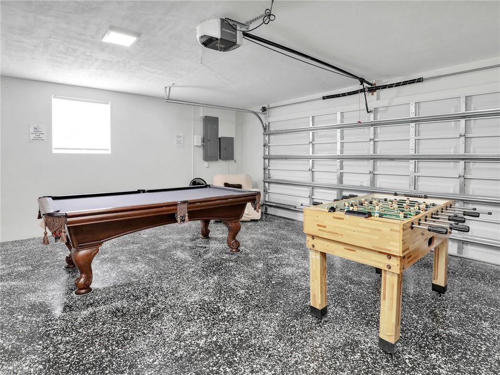 Playroom featuring a garage, billiards table, and electric panel