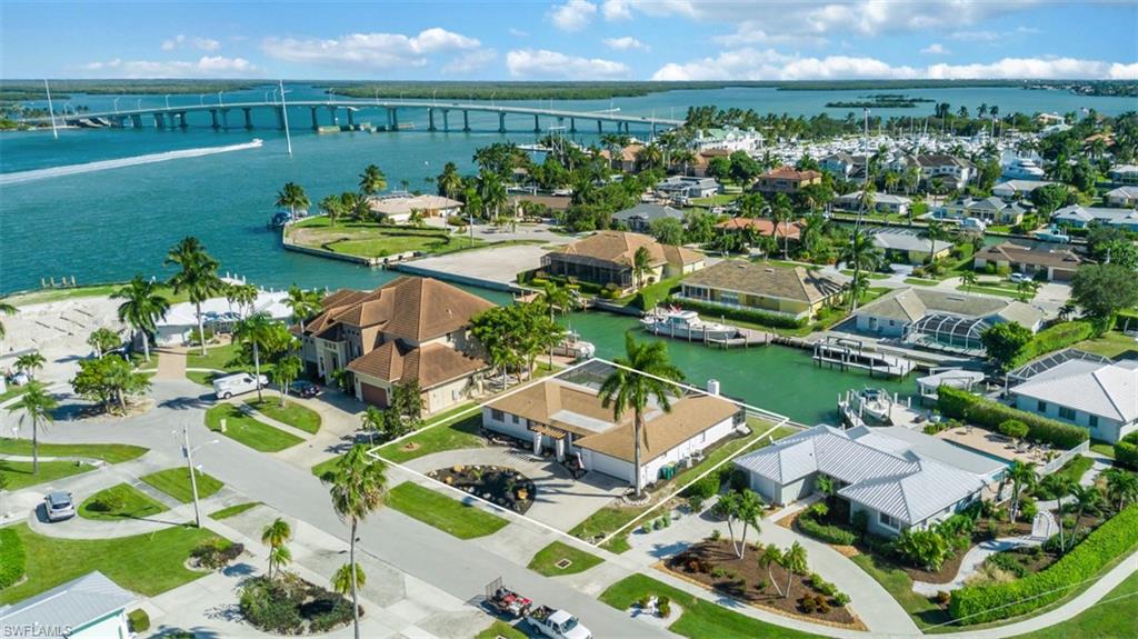 Aerial perspective of suburban area with a notable bridge and a nearby body of water