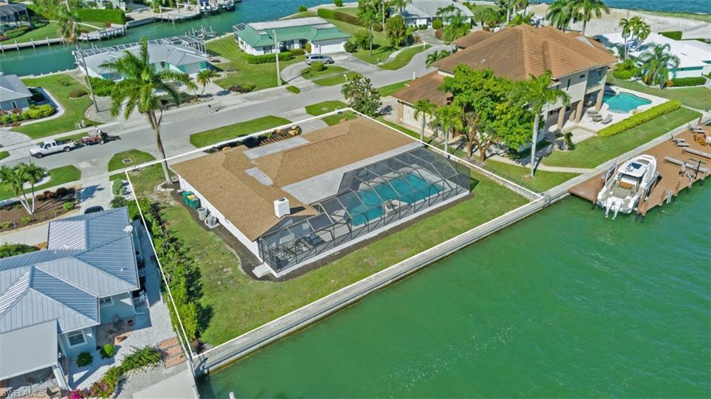 Aerial perspective of suburban area featuring a nearby body of water