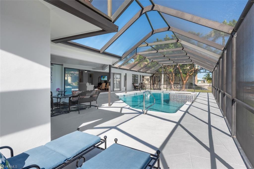 Integrated pool / spa featuring a patio area, a sunroom, and a lanai