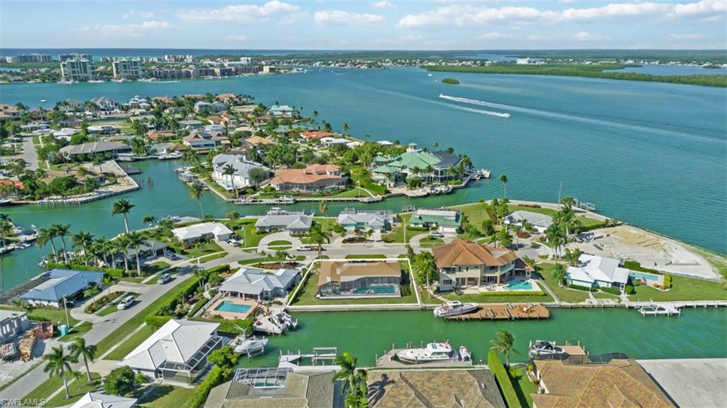 Aerial perspective of suburban area featuring a large body of water