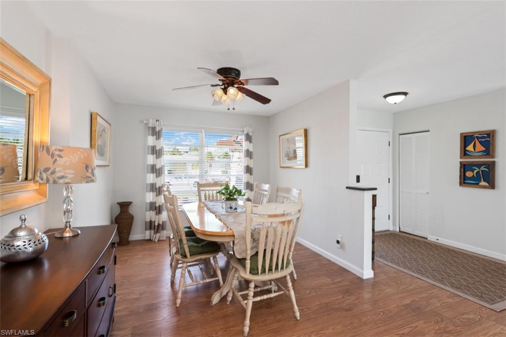 Dining space featuring dark wood finished floors and a ceiling fan