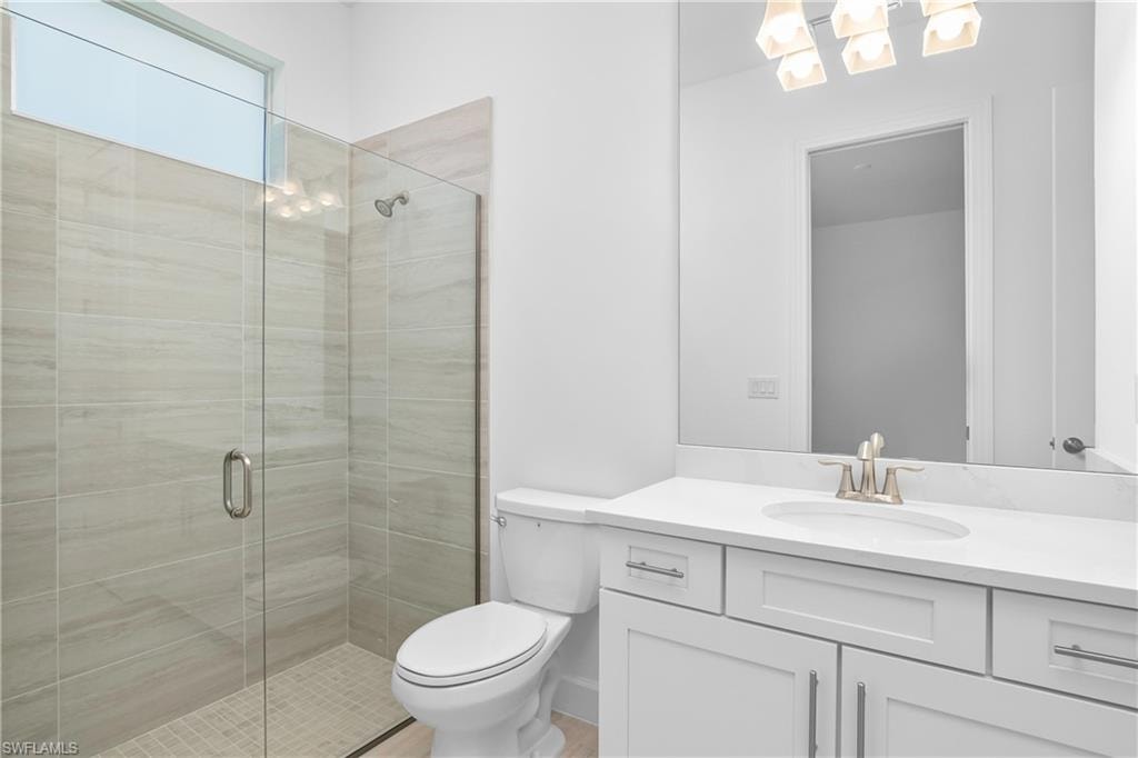 Bathroom featuring a shower stall and vanity
