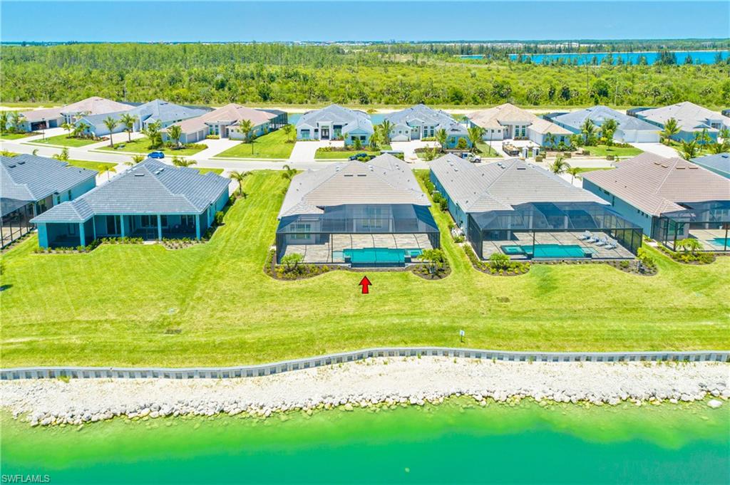 Aerial perspective of suburban area with a large body of water