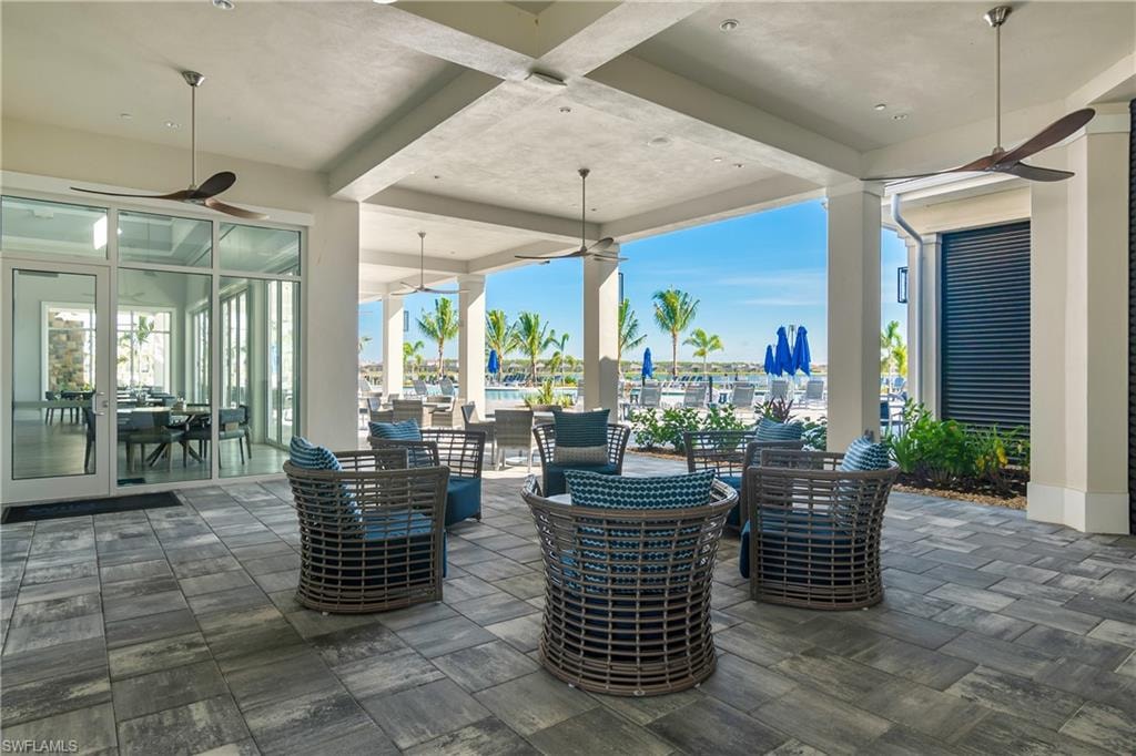 View of patio / terrace featuring a ceiling fan and an outdoor living / dining area