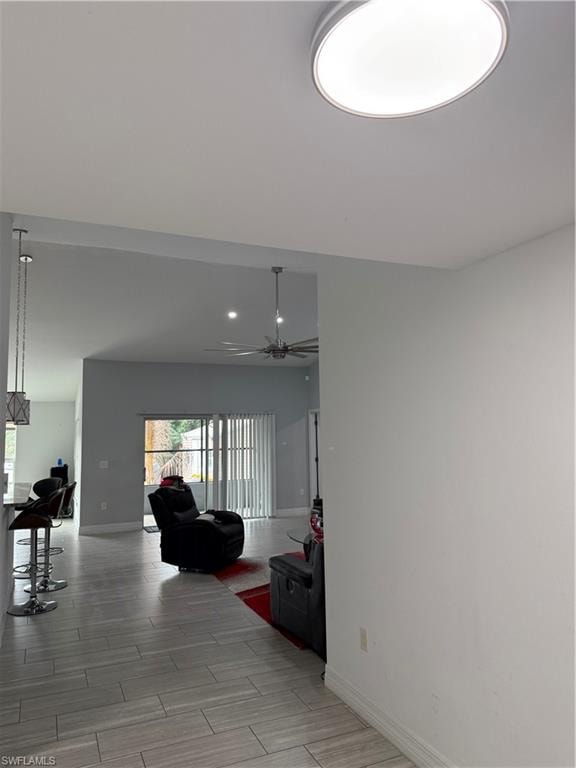 Living room featuring wood tiled floors, a ceiling fan, and recessed lighting