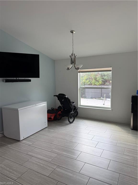 Unfurnished dining area with suspended lighting and wood finish floors