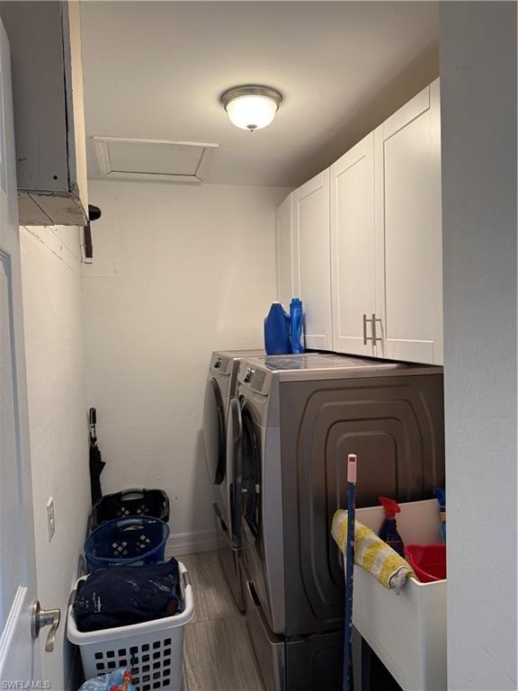 Laundry room with cabinet space and washer and clothes dryer
