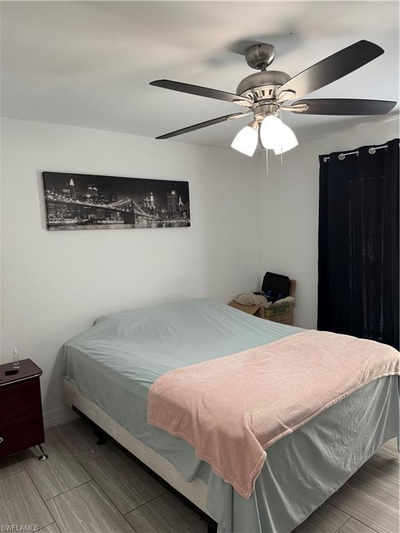 Bedroom featuring a ceiling fan and wood finish floors