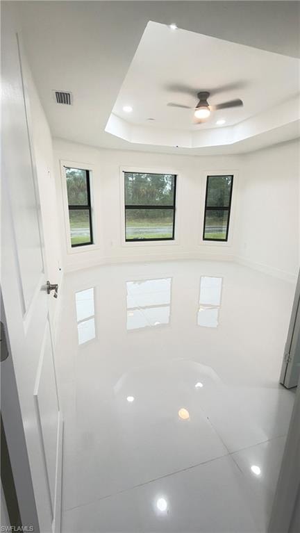 Bathroom featuring recessed lighting, a raised ceiling, and a ceiling fan
