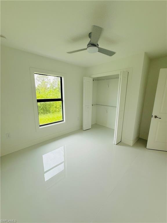 Unfurnished bedroom featuring ceiling fan and a closet