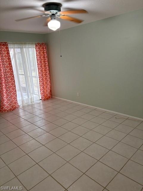 Unfurnished room with a ceiling fan and light tile patterned flooring