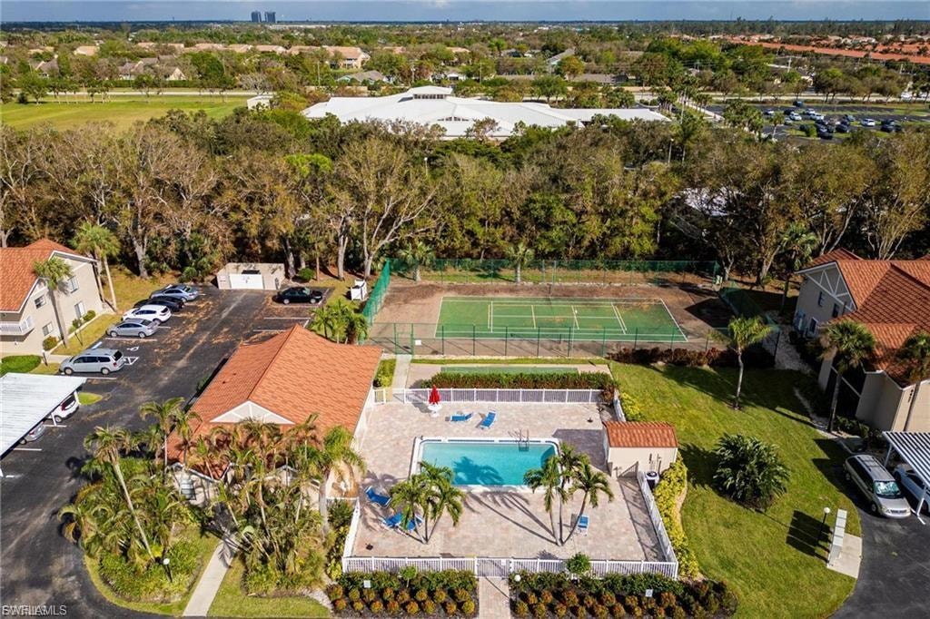 Aerial view of a pool area and a tree filled landscape