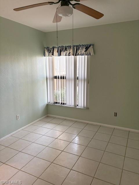 Unfurnished room with ceiling fan and light tile patterned floors