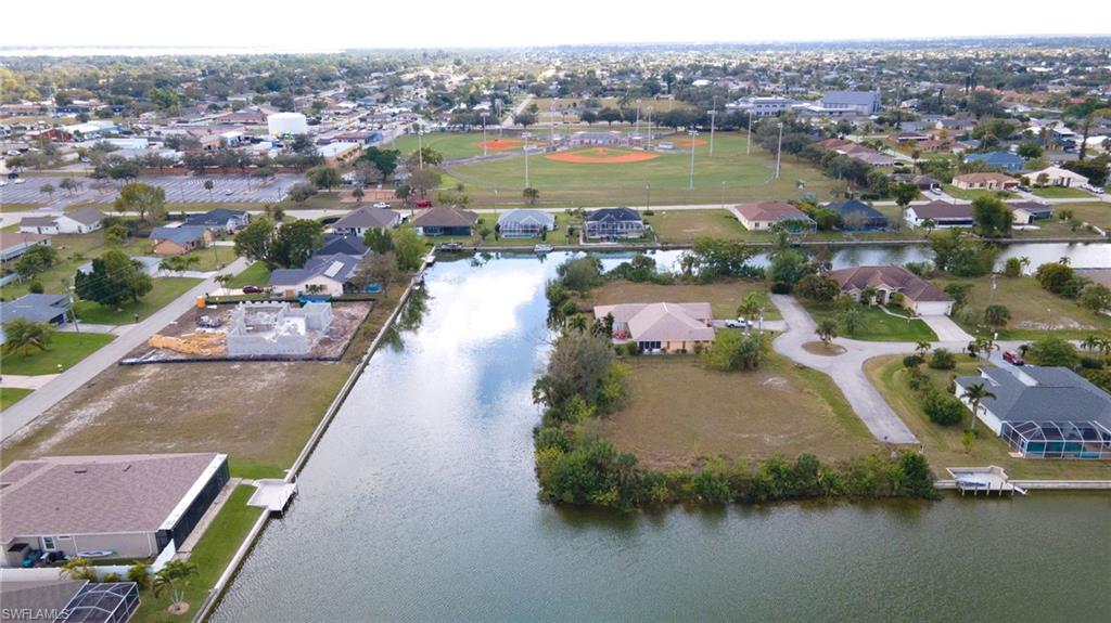 Aerial view of property's location with a large body of water and nearby suburban area