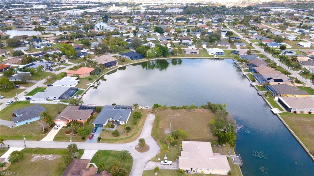 Aerial view of property's location featuring nearby suburban area and a large body of water