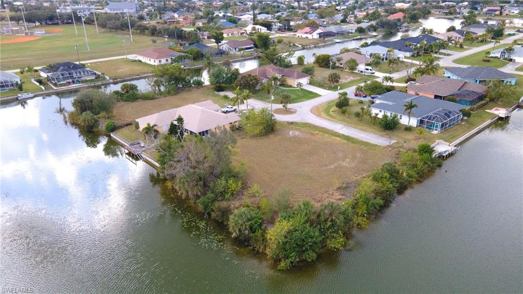 View of property location with a nearby body of water and nearby suburban area