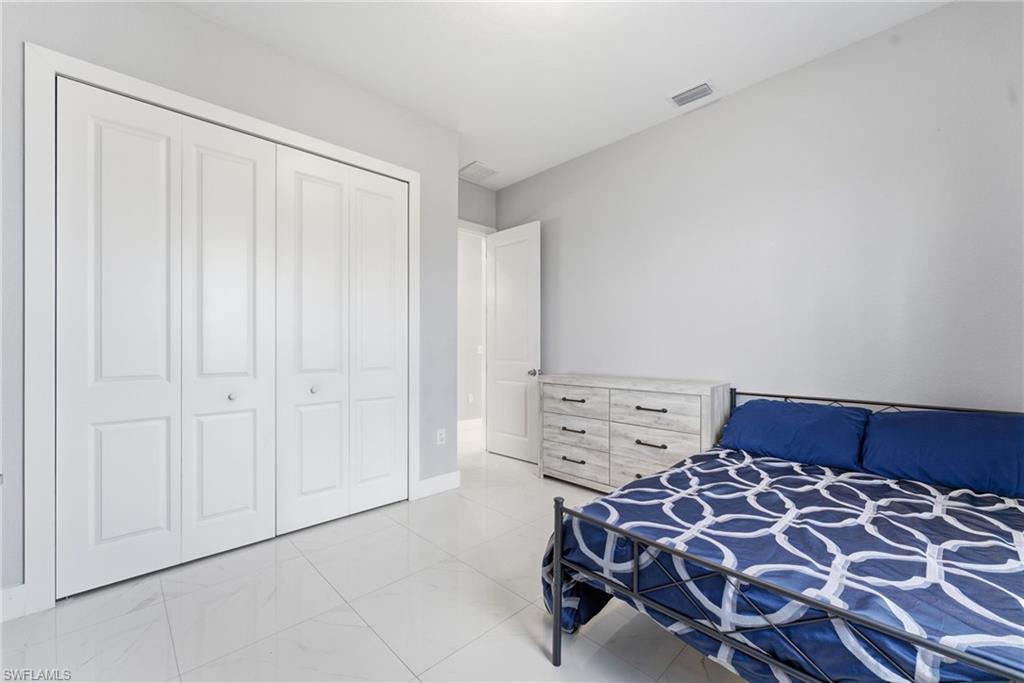 Bedroom featuring a closet and baseboards