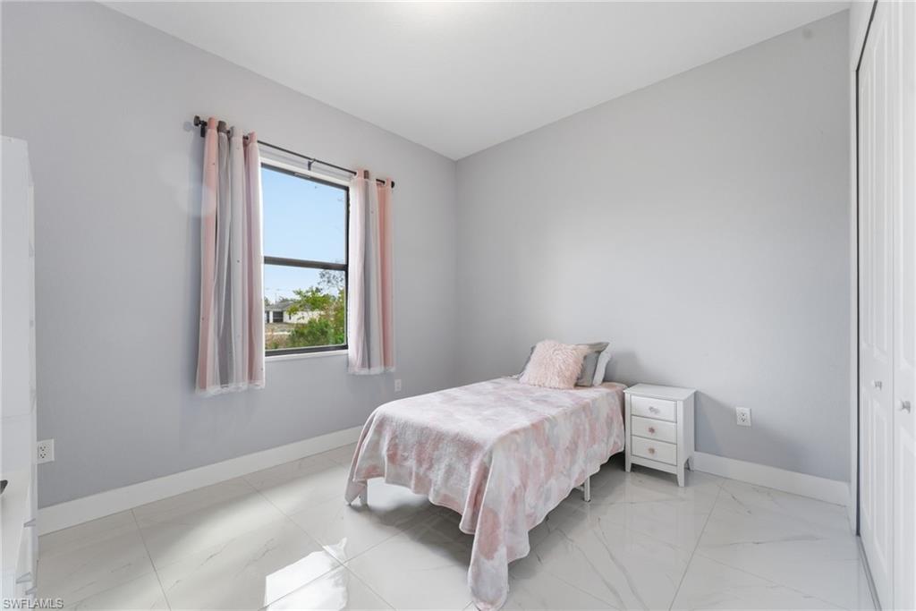 Bedroom with baseboards and a closet