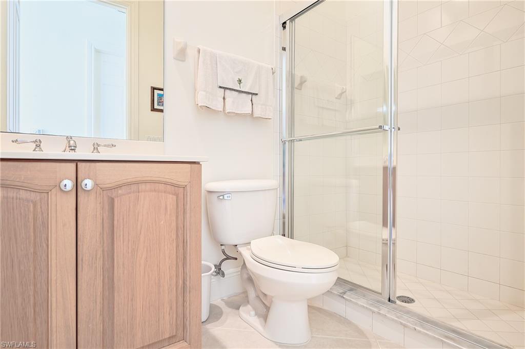 2nd Bathroom outside twin bedroom, featuring a stall shower, vanity, and tile patterned flooring