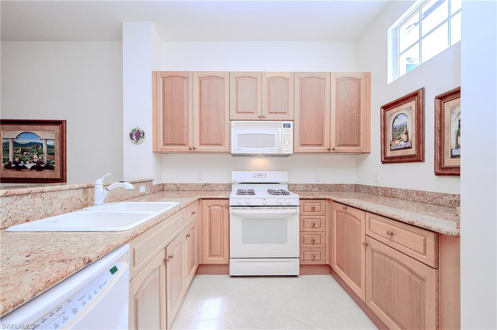 Long View of the Kitchen with coordinated granite counters, tile and appliances