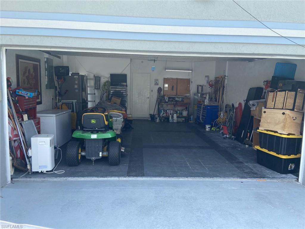 Garage with white fridge and electric panel