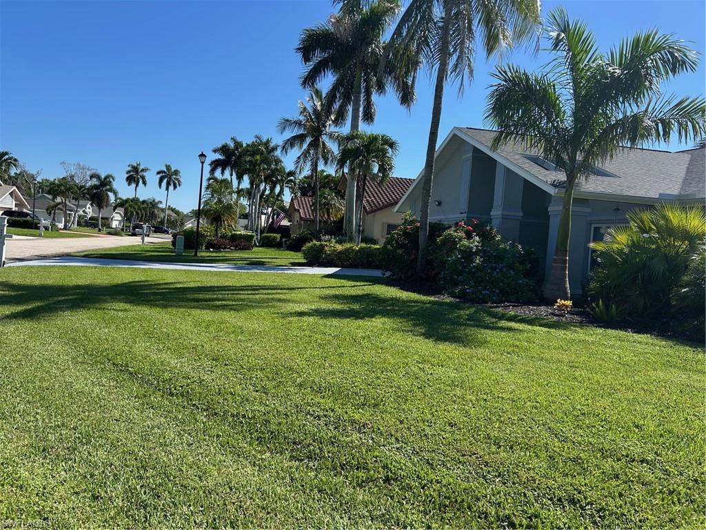 View of green lawn featuring a residential view
